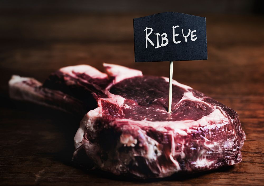 Cut of fresh rib eye steak food photography recipe idea
