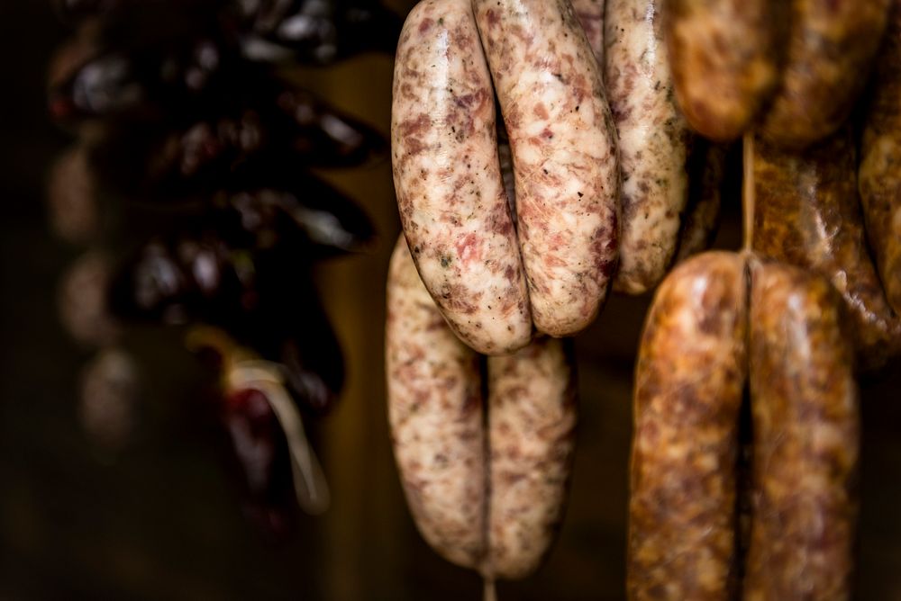 Smoked sausages hanging in a deli shop