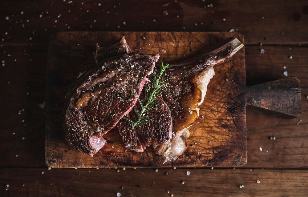 Tomahawk steak on a wooden board food photography recipe idea