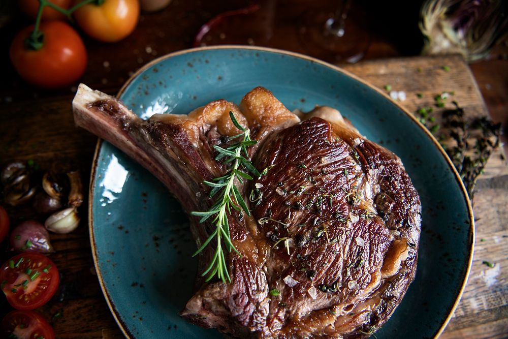 Tomahawk on a plate with rosemary food photography recipe idea