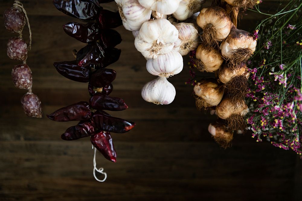 Garlic and flowers hanging by the wall