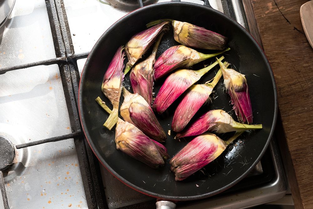 Artichokes cooking in a sauce pan