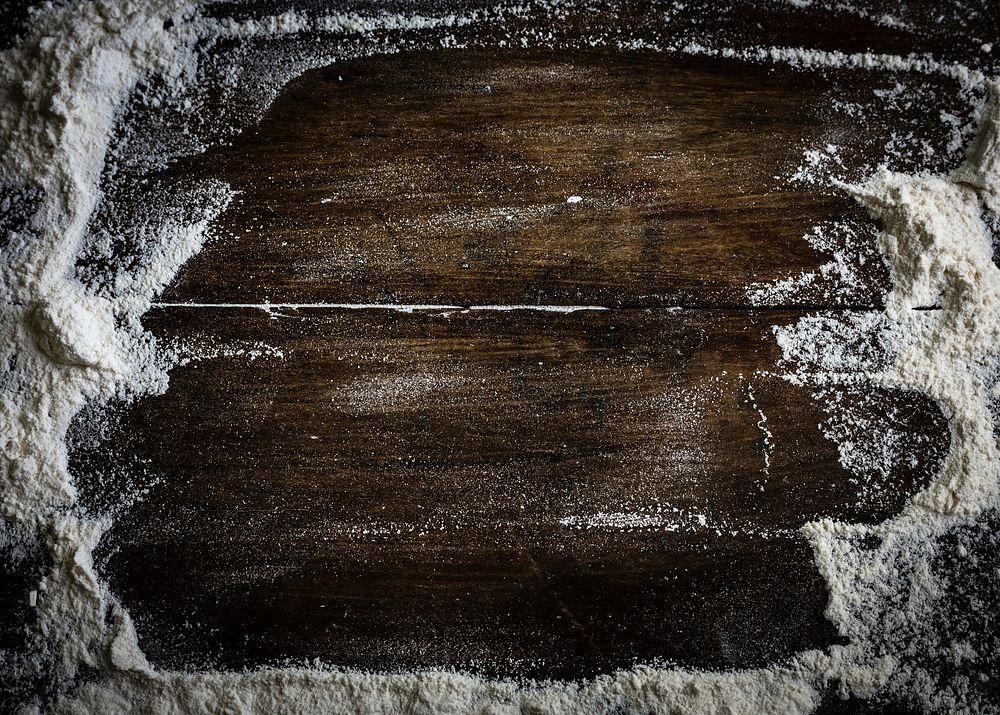 Flour scattered on a wooden table