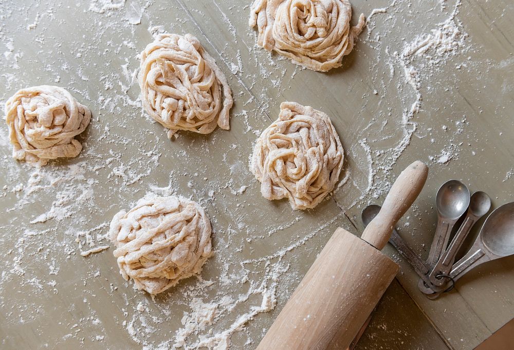 Raw tagliatelle nests on a table