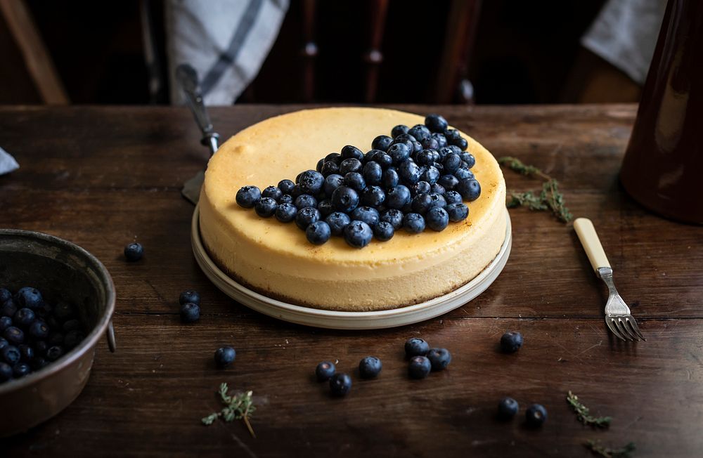 Cheesecake decorated with blueberries on a table