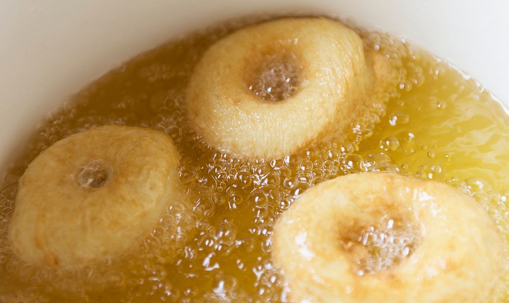 Donuts deep frying in a pot