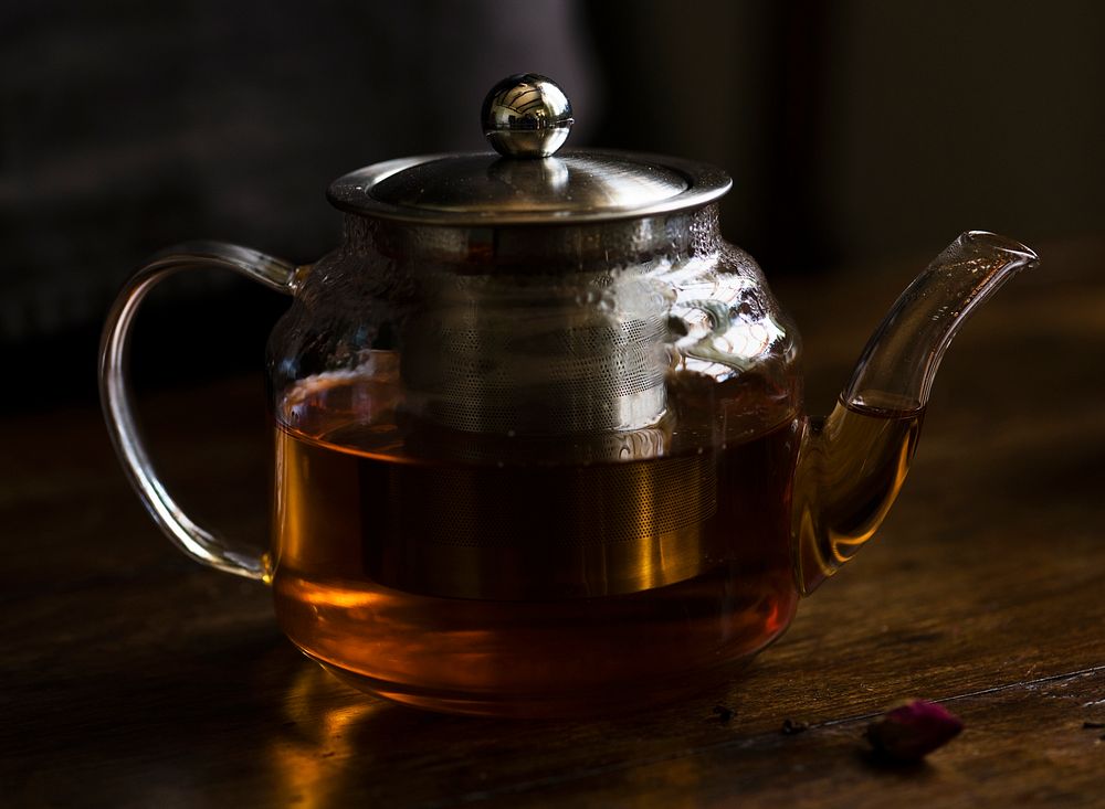 Teapot with hot tea on a table