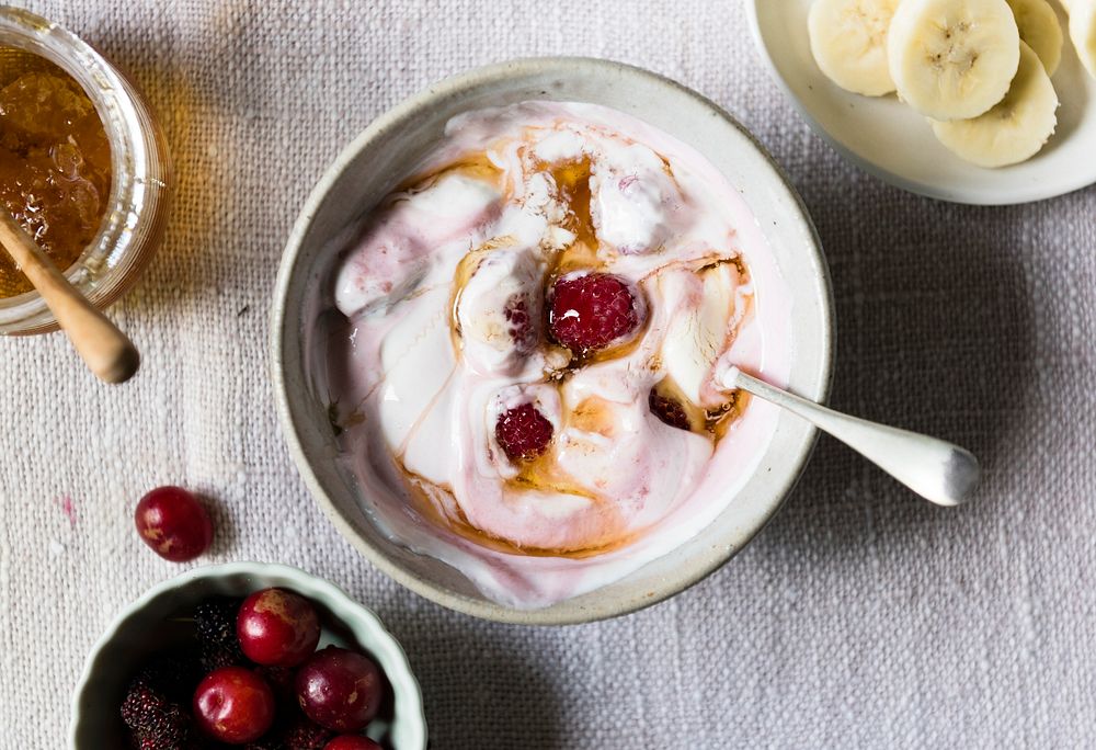 Yogurt bowl filled with raspberries and bananas
