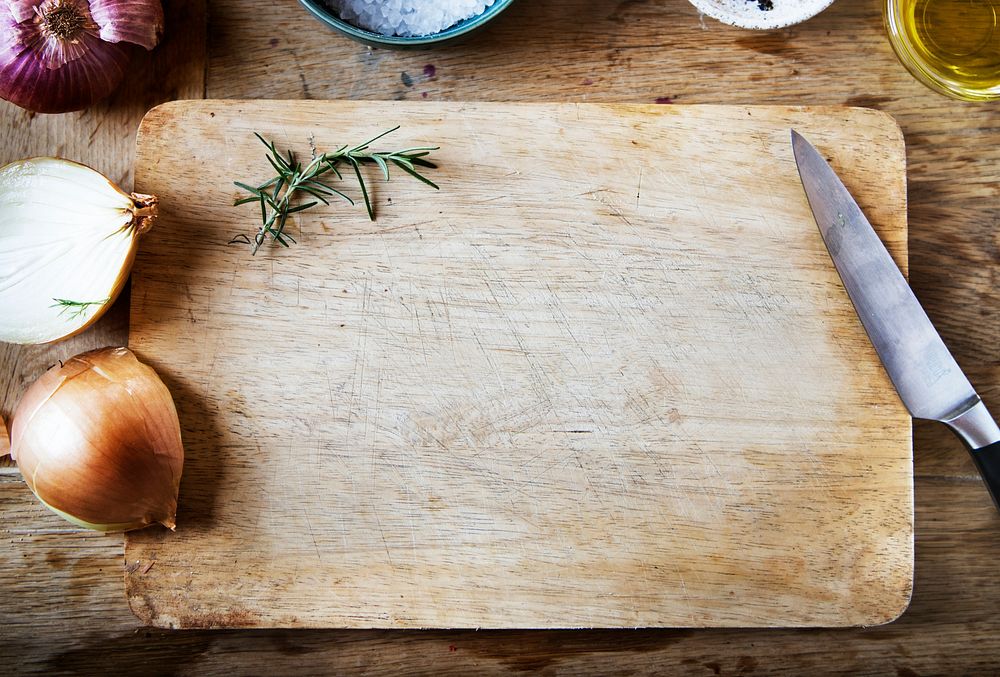 Cutting board and vegetables on a wooden table