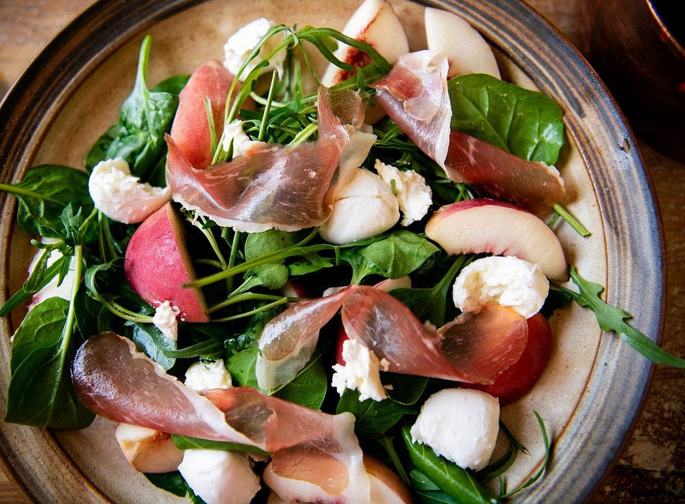 Spinach salad with parma ham and mozarella cheese food photography