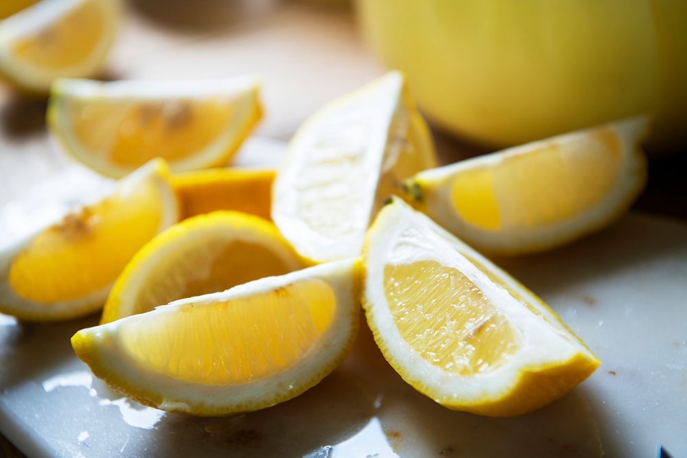 Freshly sliced yellow lemons on a cutting board