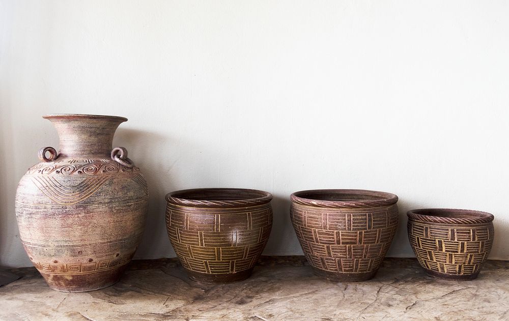 Handmade antique pottery by a wall