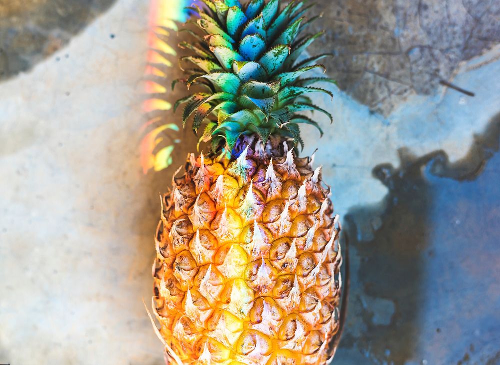 Closeup of fresh pineapple with rainbow prism light