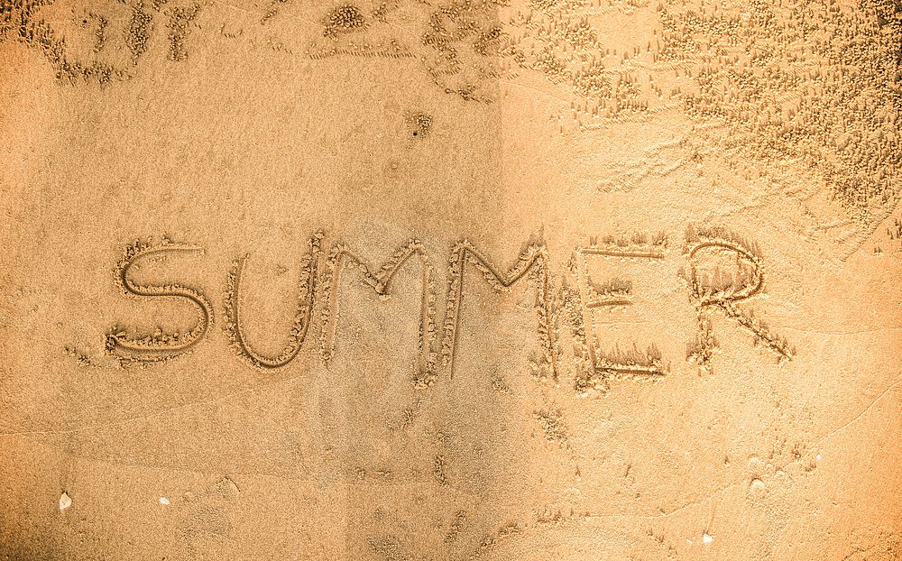 Summer written in the sand