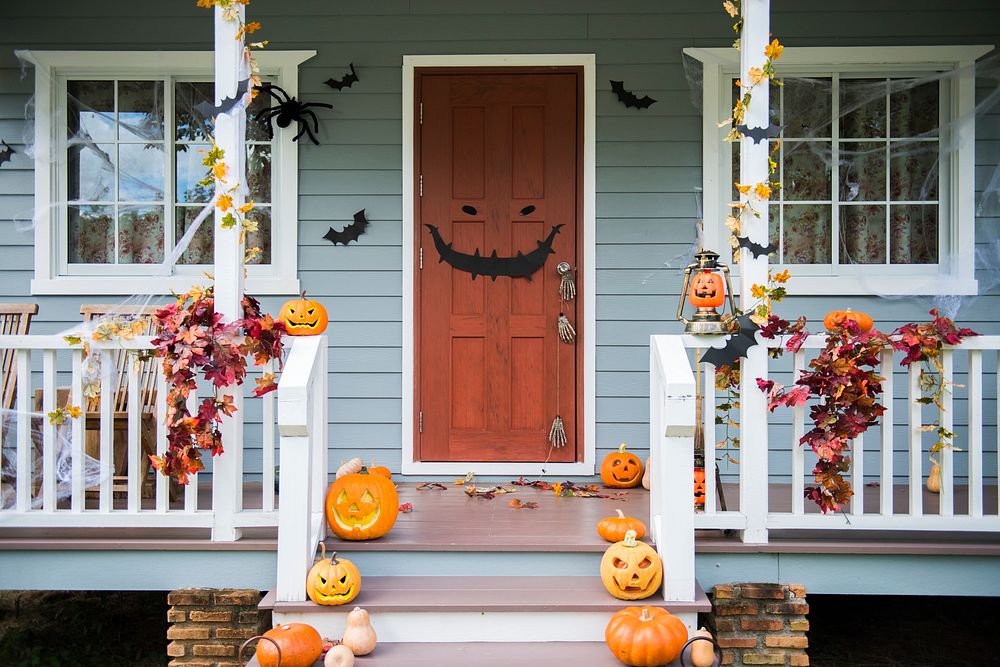 Halloween pumpkins and decorations outside a house