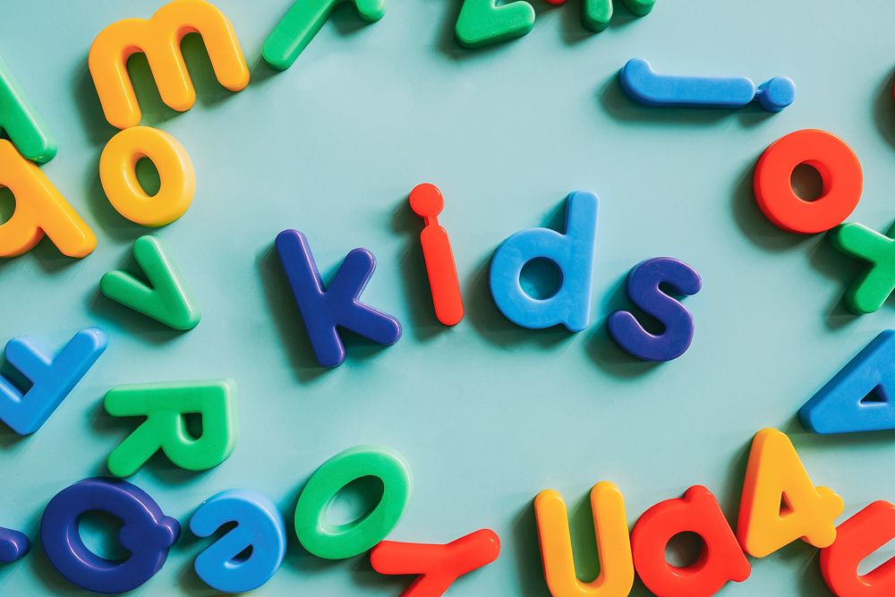 Colorful alphabet letters on a table spelling kids