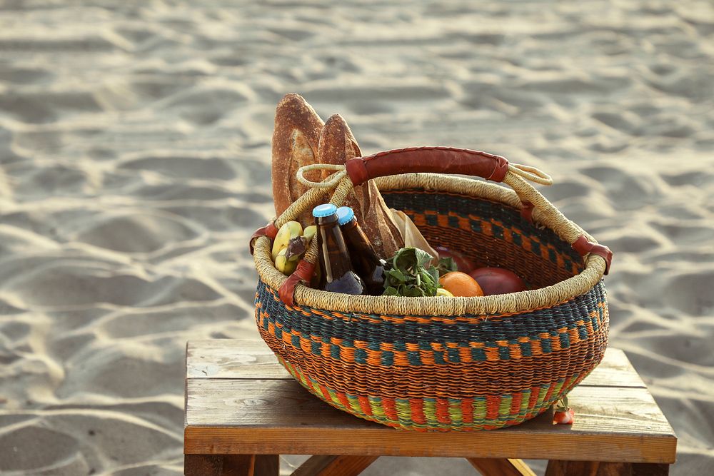 Picnic basket filled with snacks and drinks at the beach