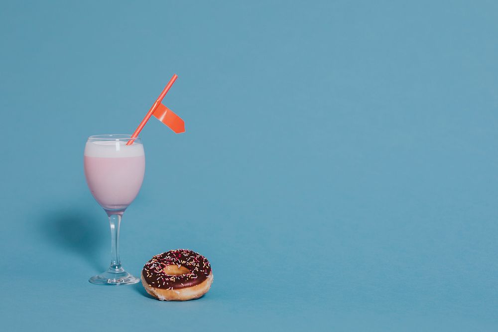 Tasty glazed donut with a fancy drink