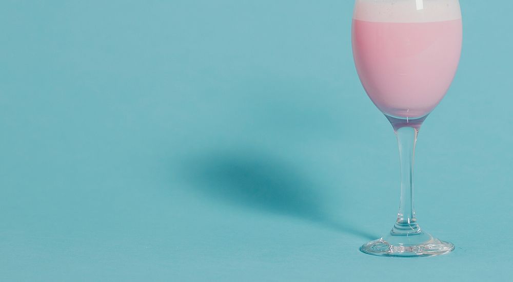 Cute pink fancy drink in a wine glass