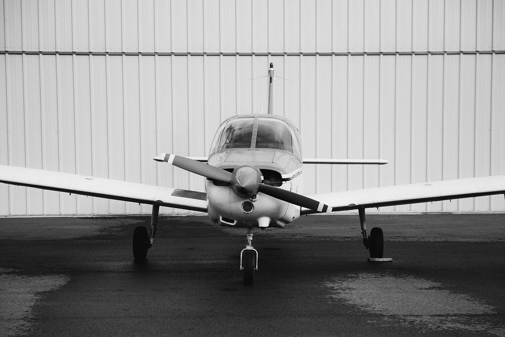 Front propellor plane in black and white
