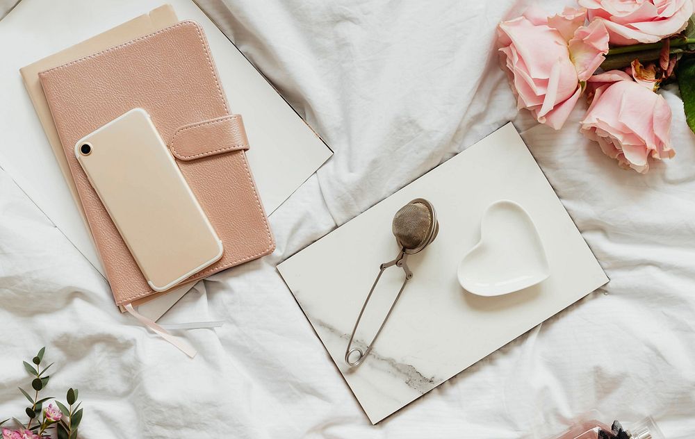 Romantic and feminine flat lay on a bed