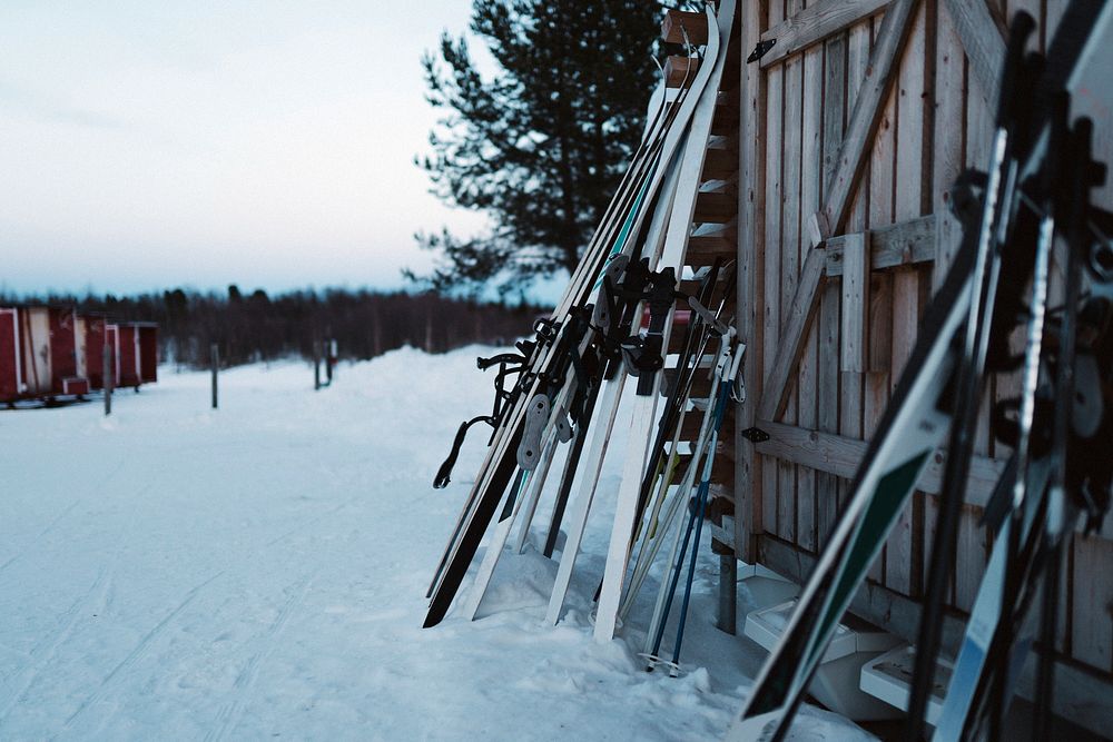 Skis by a log cabin