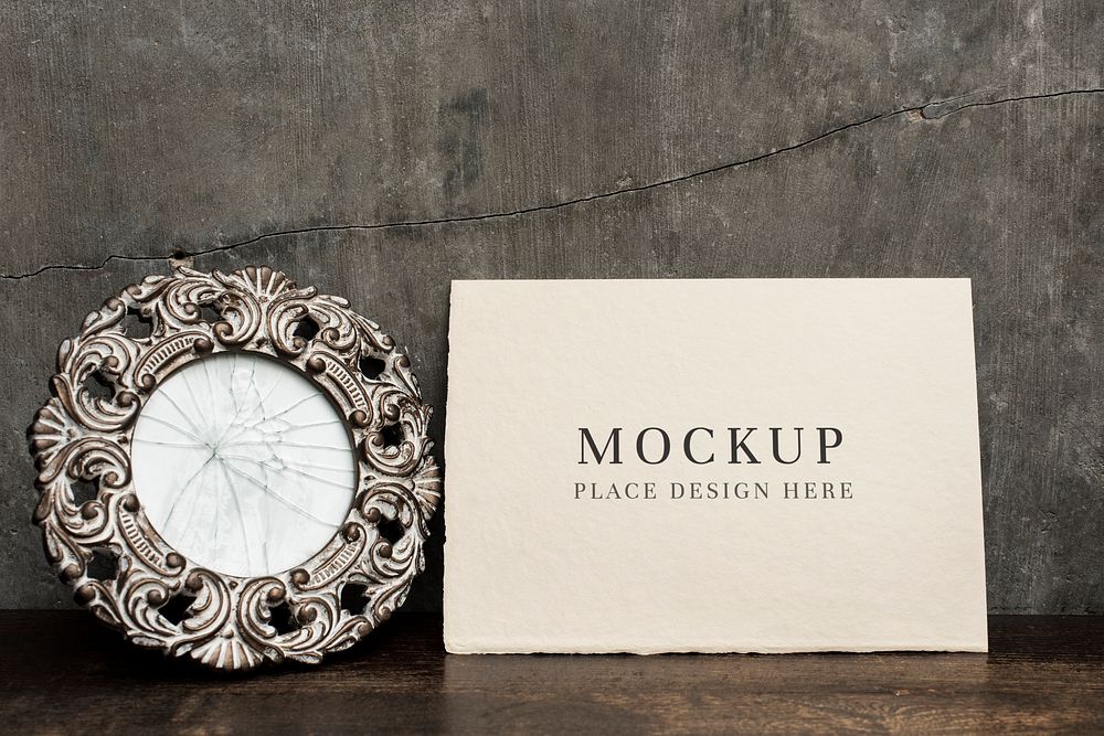 Beige card mockup by a cracked mirror on a wooden table