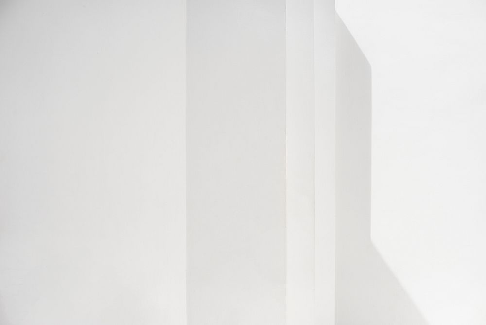 Blank white wall with shadows