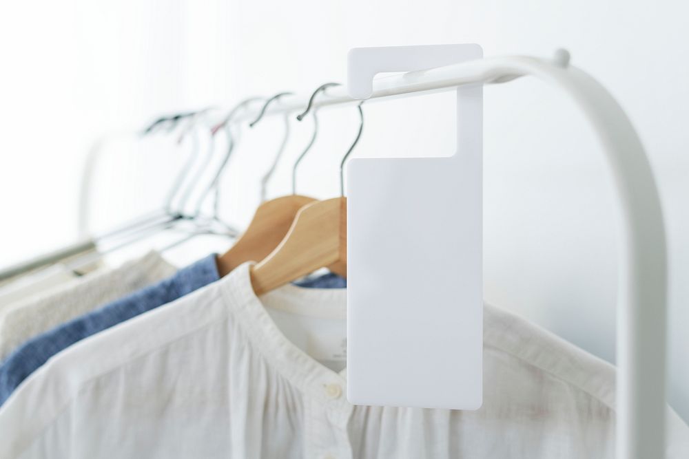 Shirt on a clothing rack with a tag mockup in a studio