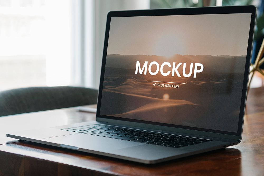 Laptop mockup on a wooden table in a meeting room