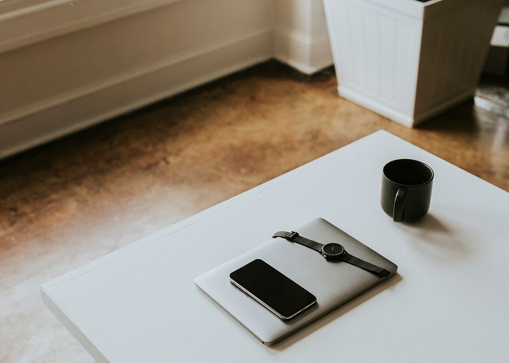 Digital devices by a coffee mug on a desk