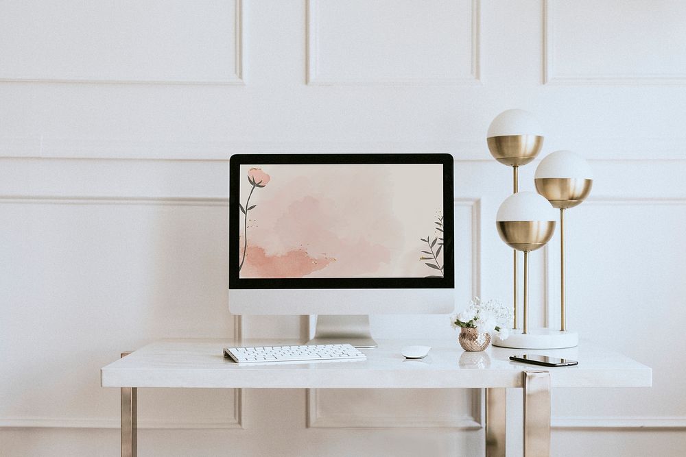 Computer screen mockup by a golden lamp