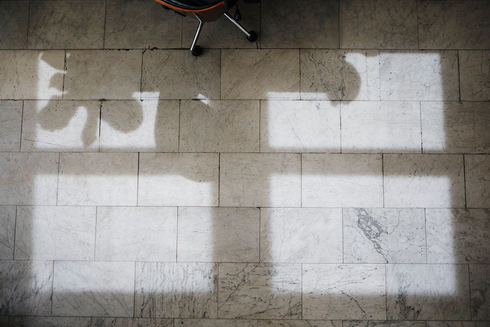 Shadows on a marble tile through the window