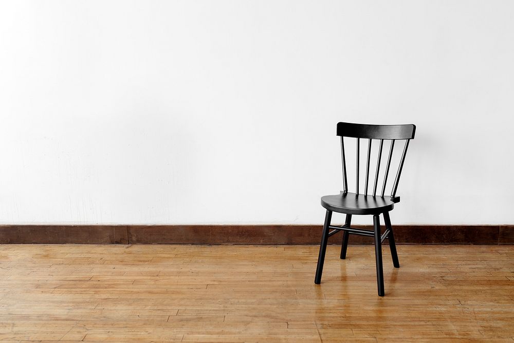 A chair against a white wall