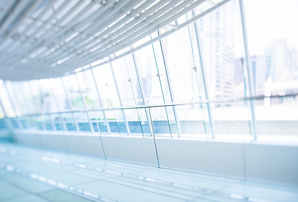 Empty hallway with glass walls overlooking the city