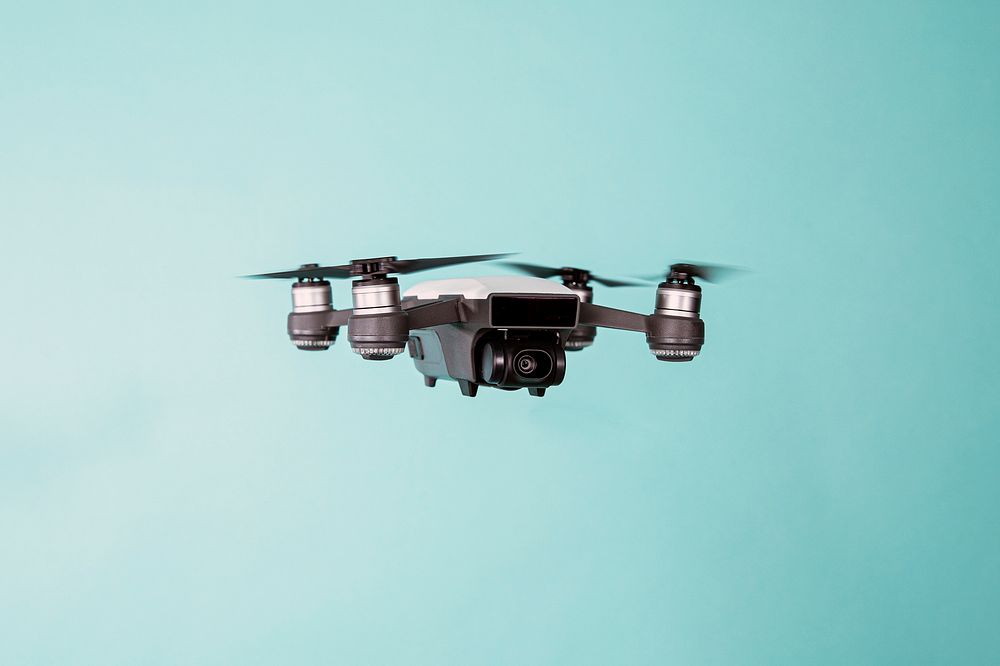 Flying drone on blue background