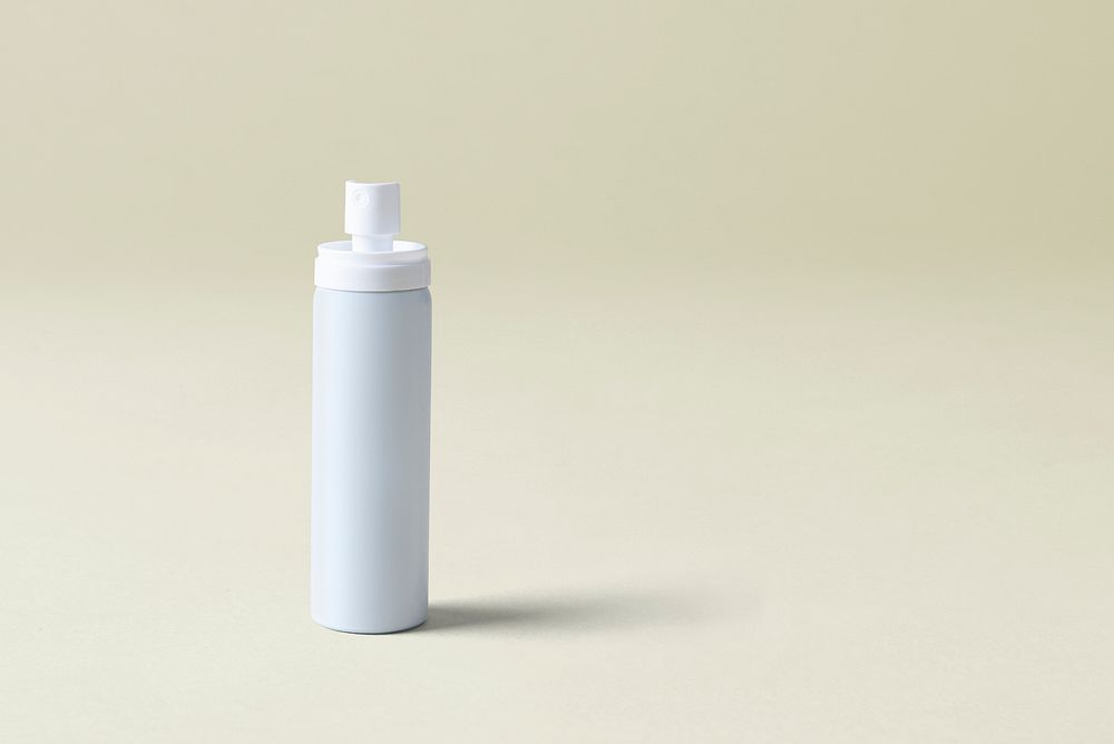 White spray bottle psd mockup on a beige background