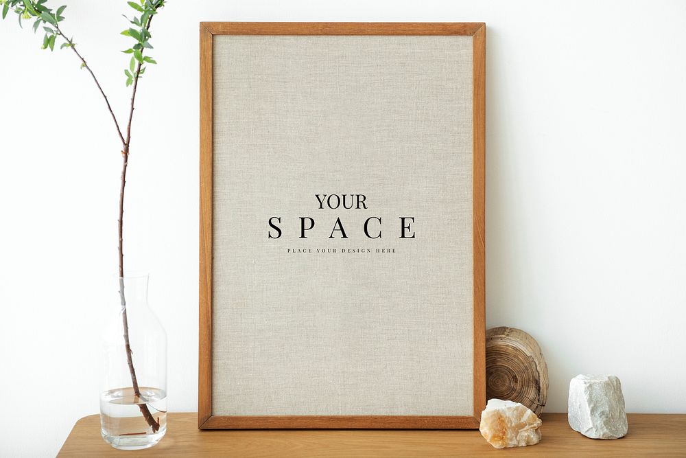 Blank wooden picture frame mockup against a white wall