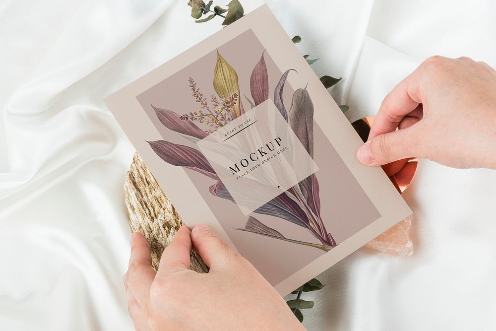 Hands holding floral card mockup