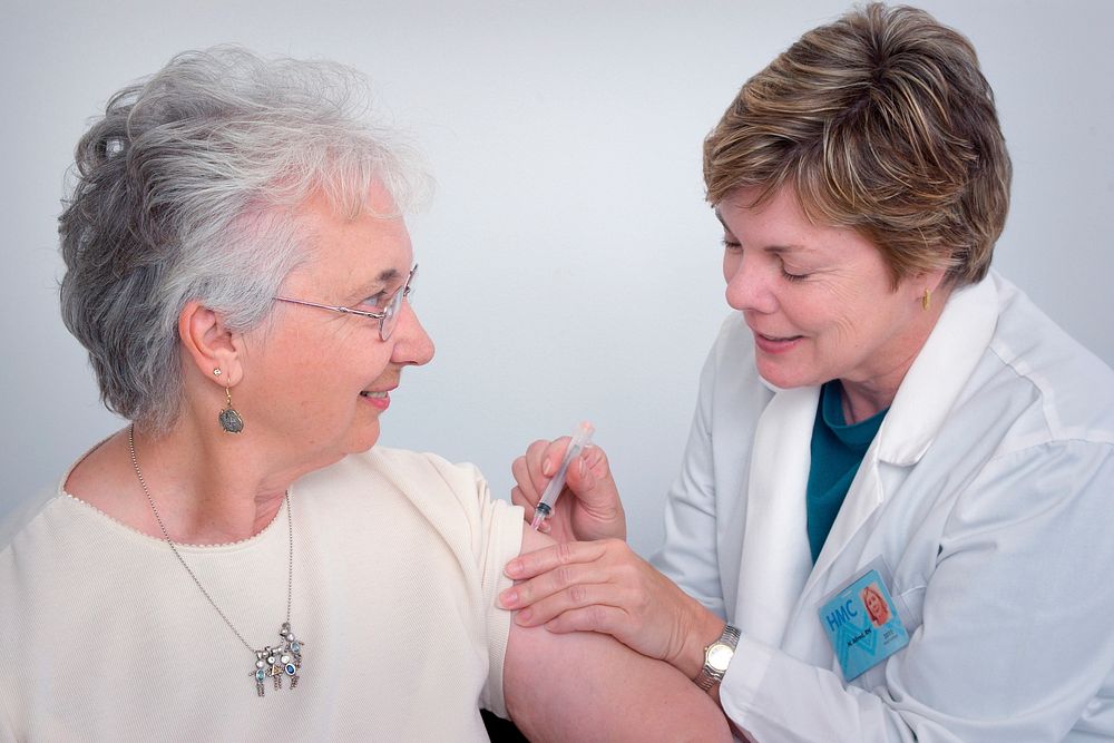 A doctor administering an intramuscular immunization to a middle&ndash;aged woman. Original image sourced from US Government…