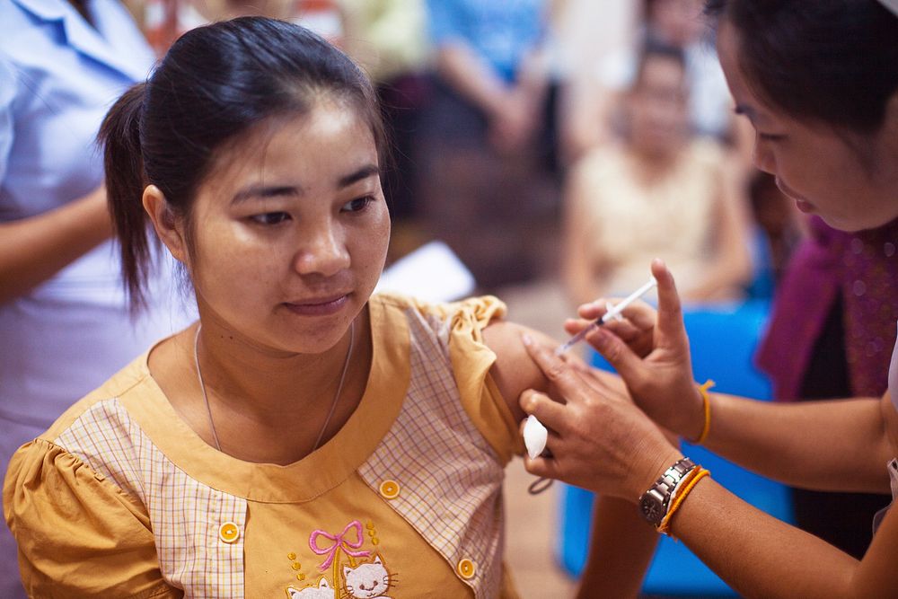 A woman receiving an influenza vaccination at the Maternal and Child Hospital in Vientiane, Laos. Original image sourced…