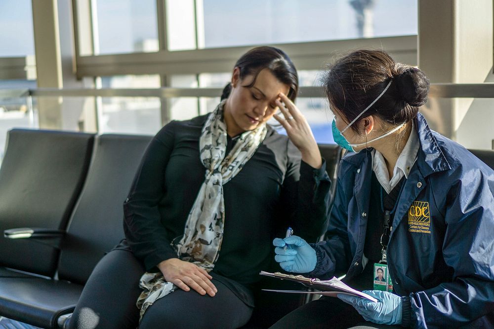 A healthcare worker assessing a sick traveler at the airport. Original image sourced from US Government department: Public…