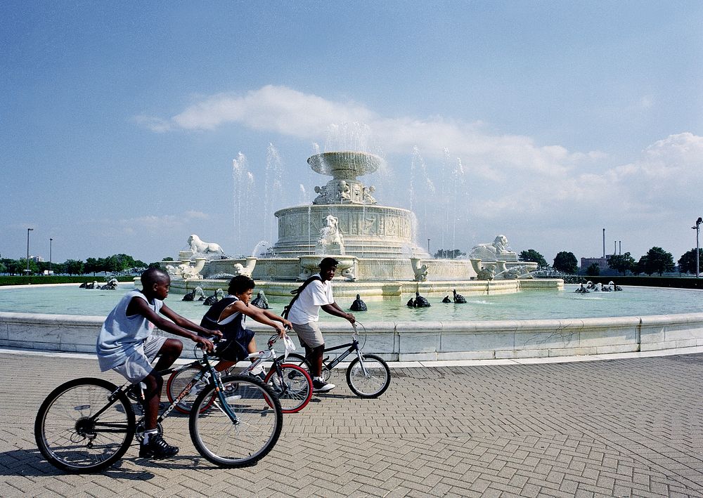 Bicyclists round the James Scott Memorial Fountain on Detroit's Belle Isle, a once-posh island park in the Detroit River…