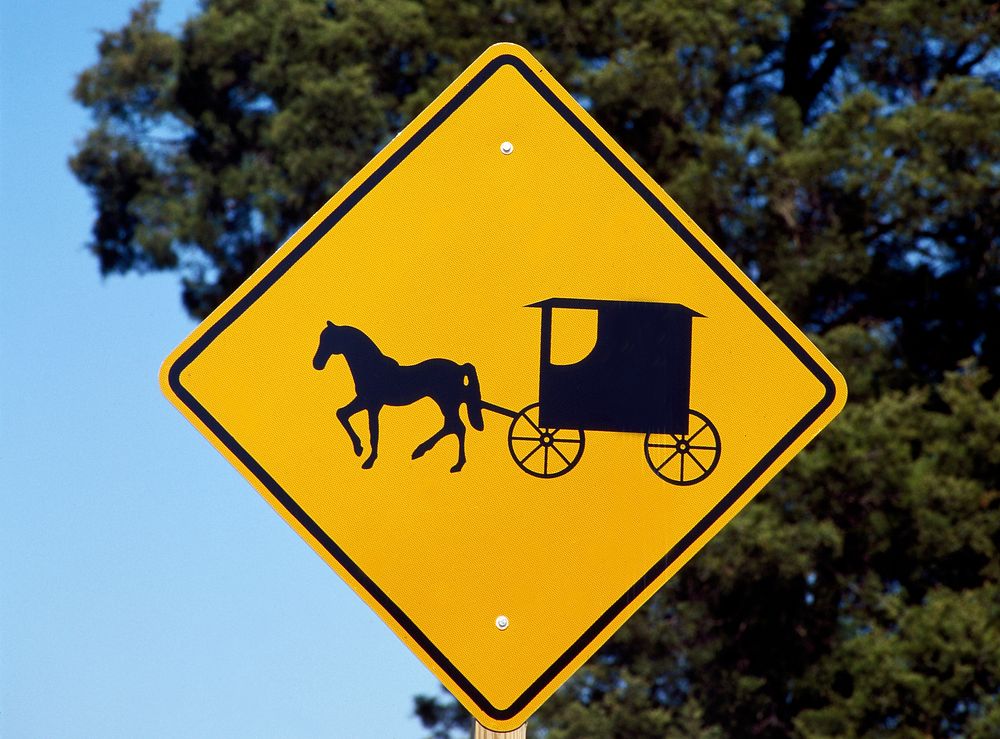 A caution sign to auto drivers to be on the lookout for Amish horses and buggies. Original image from Carol M.…