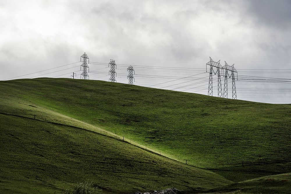 Lush green hills frame rows of power lines west of Modesto in California's San Joaquin Valley. Original image from Carol M.…