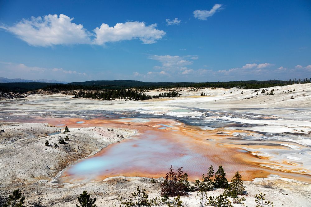 Mudpots and hot springs color the terrain in northwestern Wyoming's Yellowstone National Park. Original image from Carol M.…
