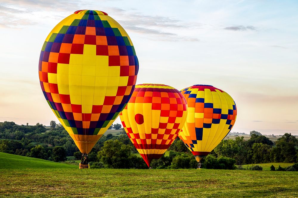 Colorful balloons land at the National Balloon Classic, a hot air balloon exhibition in Indianola, Iowa, a town near the…