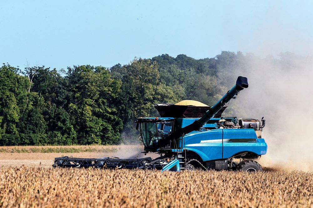 A harvester kicks up dust in a cornfield near Bridgeton in Parke County, Indiana. Original image from Carol M.…