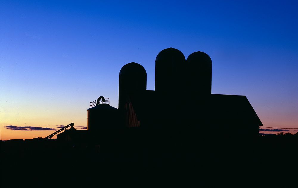 Sunset casts a glow over this dairy barn in Bruce, in northern Wisconsin. Original image from Carol M. Highsmith’s America…