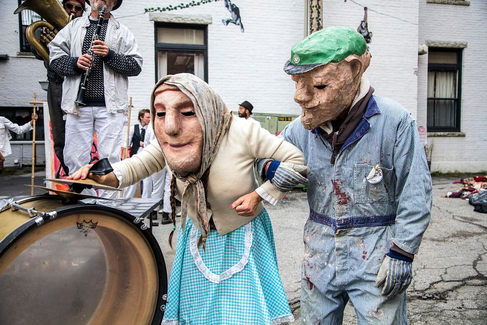 Performers in bizarre puppet masks from the Bread and Puppet Theater in Glover, Vermont. Original image from Carol M.…